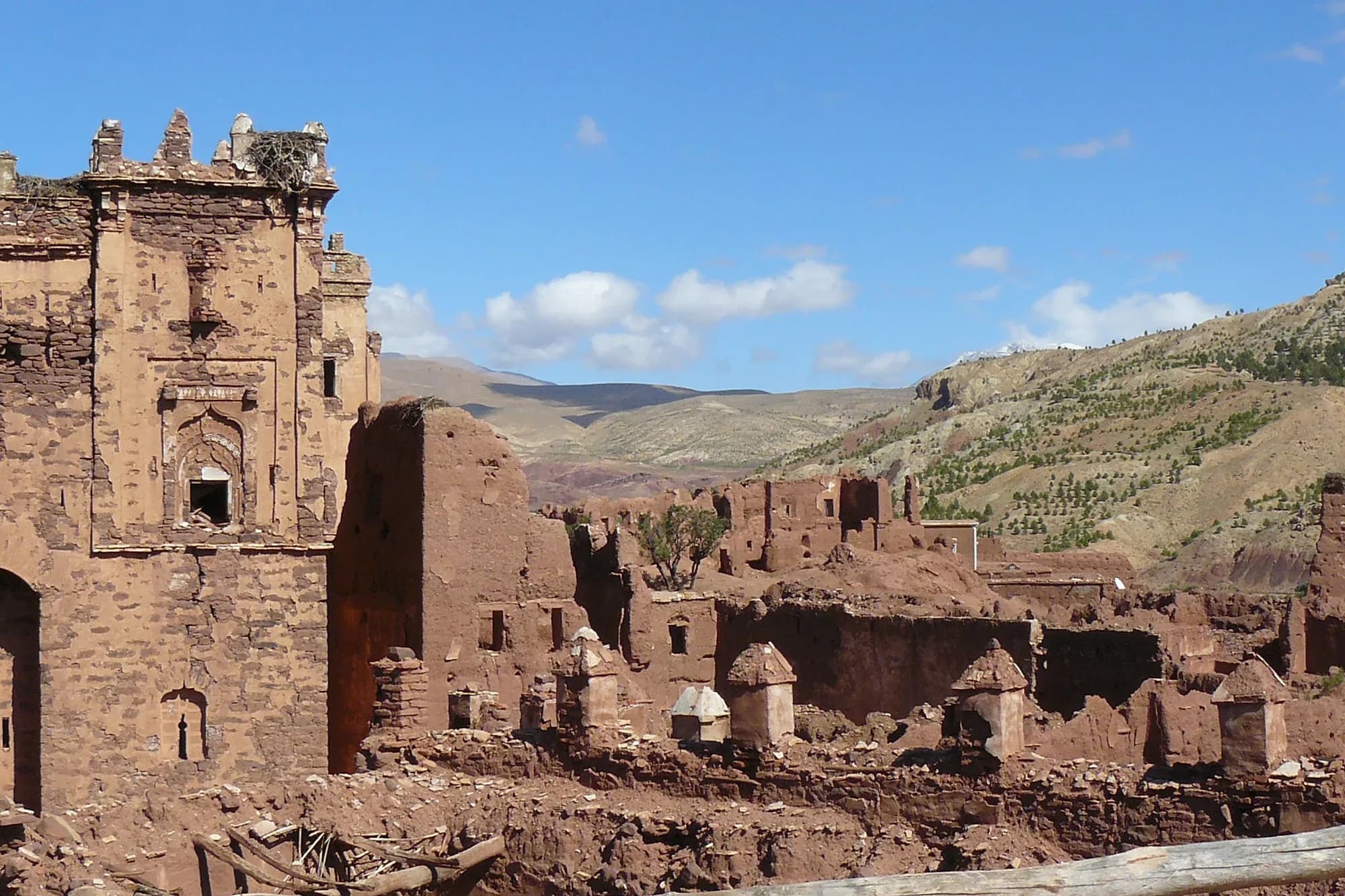 Ruined tower and walls of the Telouet kasbah with the High Atlas hills in the background