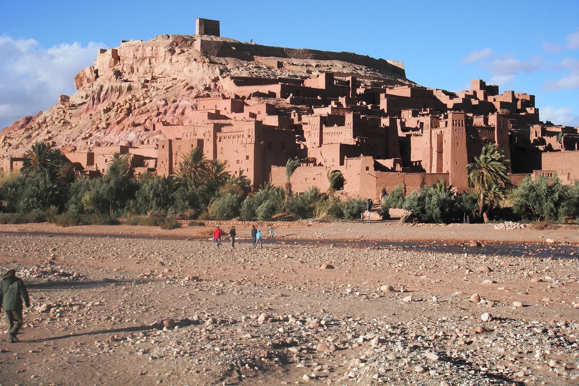 The ksar of Aït Ben Haddou seen from the dry riverbed, with the granary atop the hill