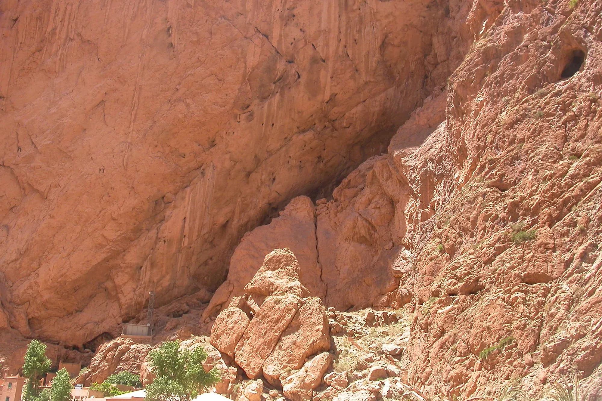 Huge reddish rock wall above the floor of the Todra Gorge
