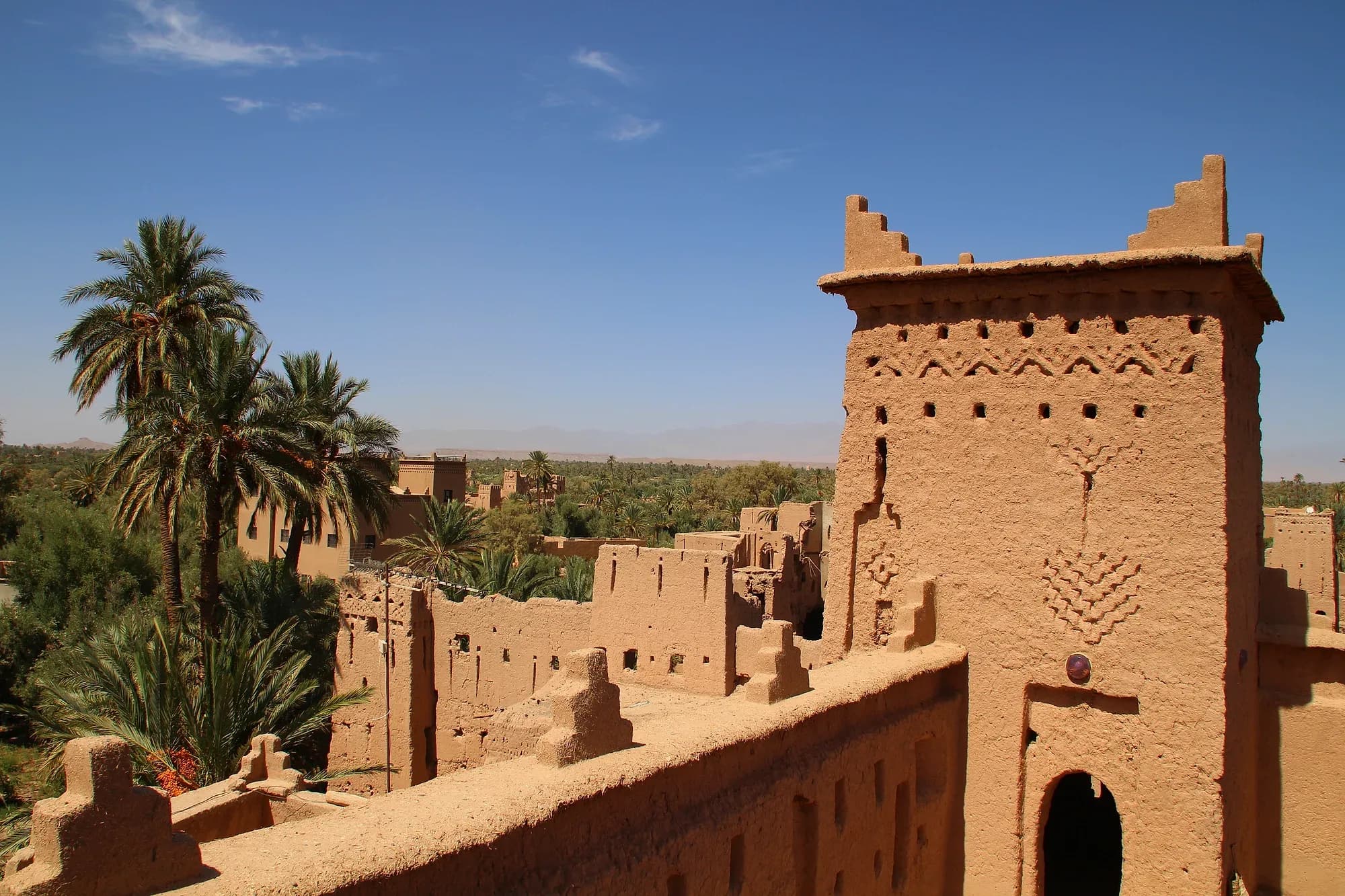Mud-brick kasbah with a decorated tower in the Skoura palm grove
