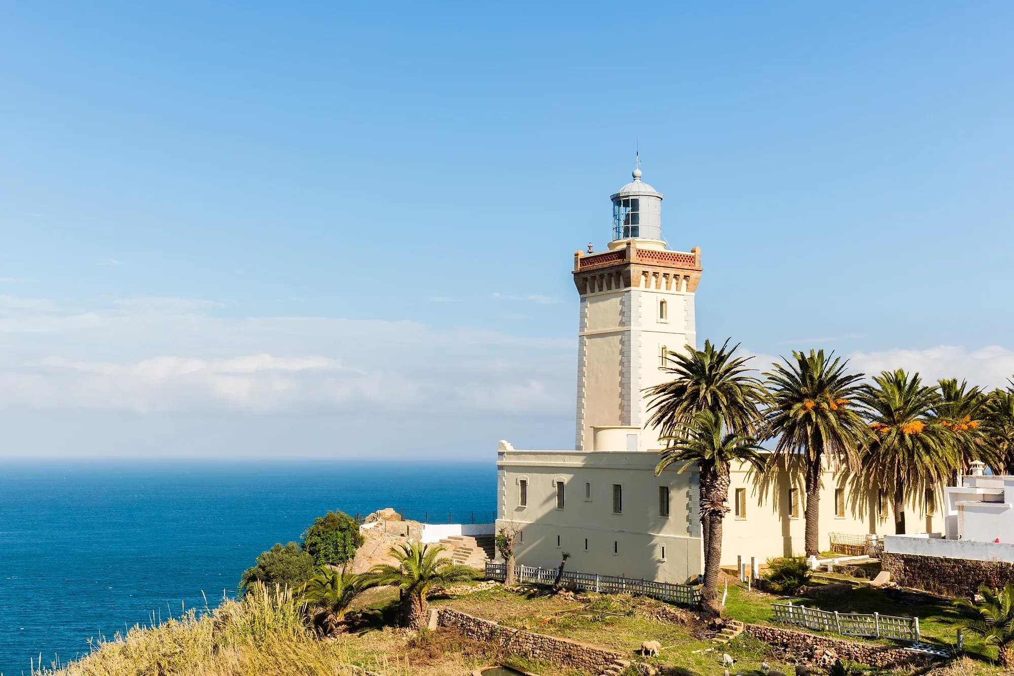 Cape Spartel lighthouse among palm trees above the sea at the mouth of the Strait, near Tangier