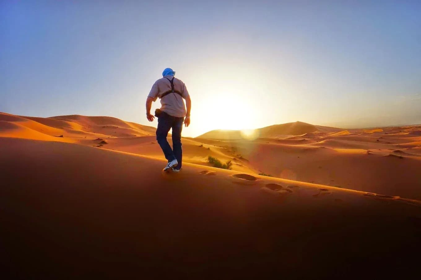 Walker on the dunes at sunset