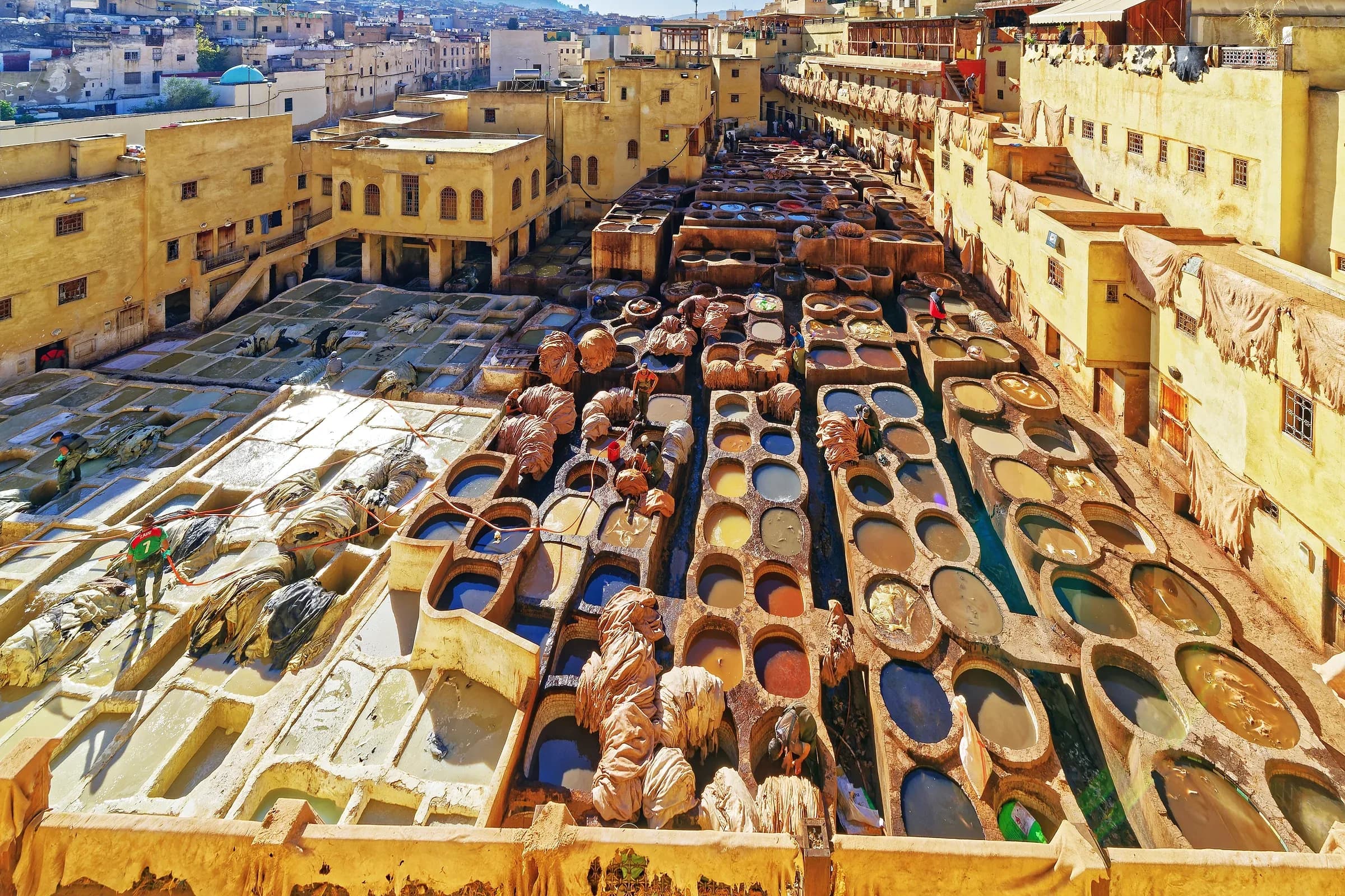 Chouara tannery in Fez seen from a terrace, with its coloured vats and the medina behind