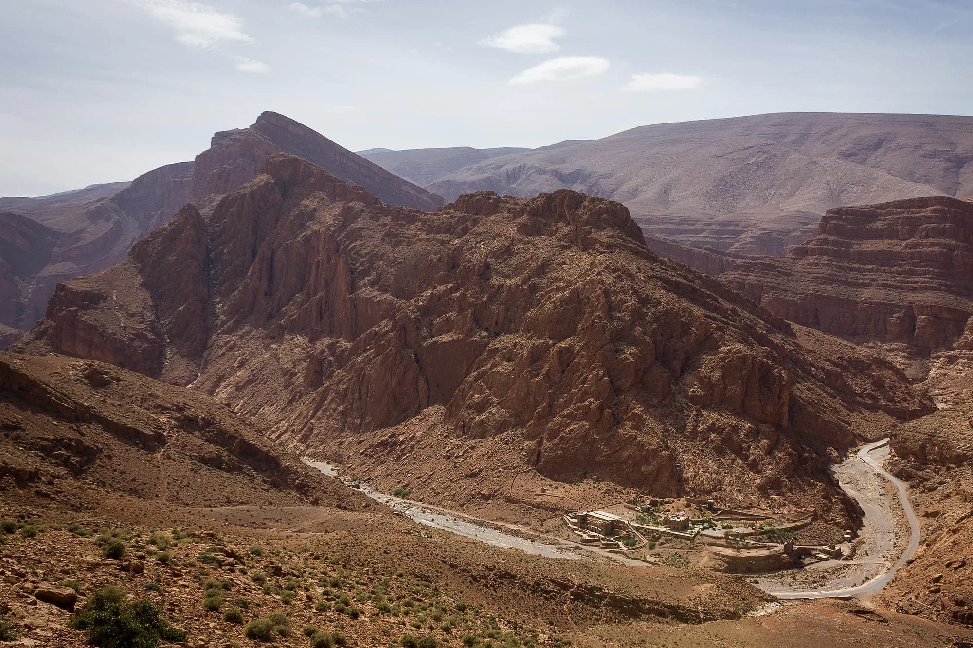 Road winding through the Todra Gorge valley between arid mountains