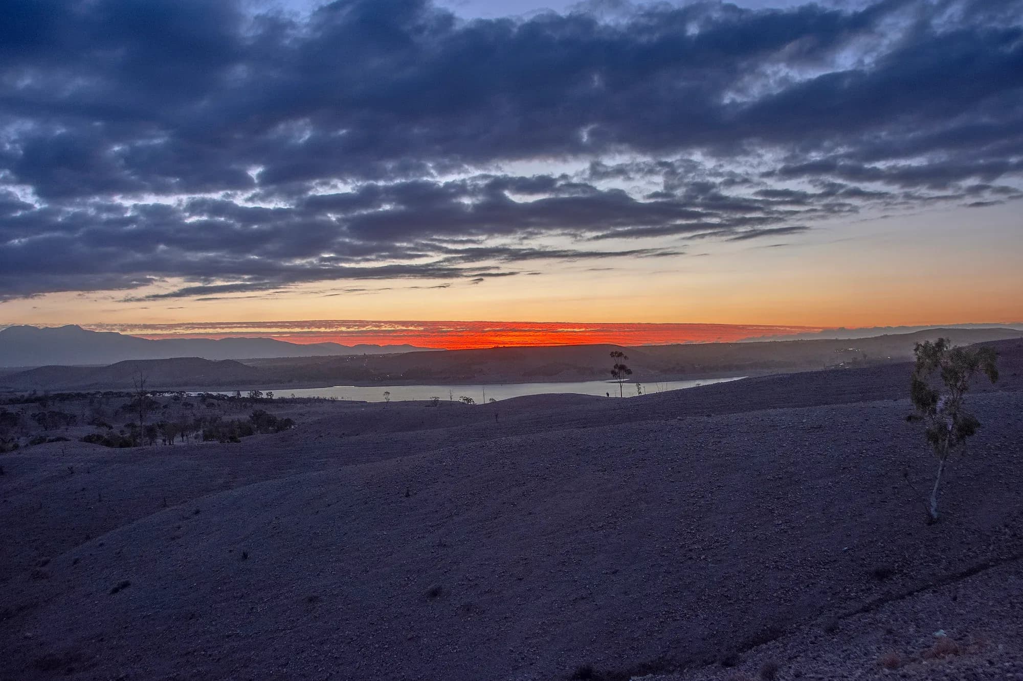 Sunset with clouds over the hills of the Agafay Desert, near Marrakech