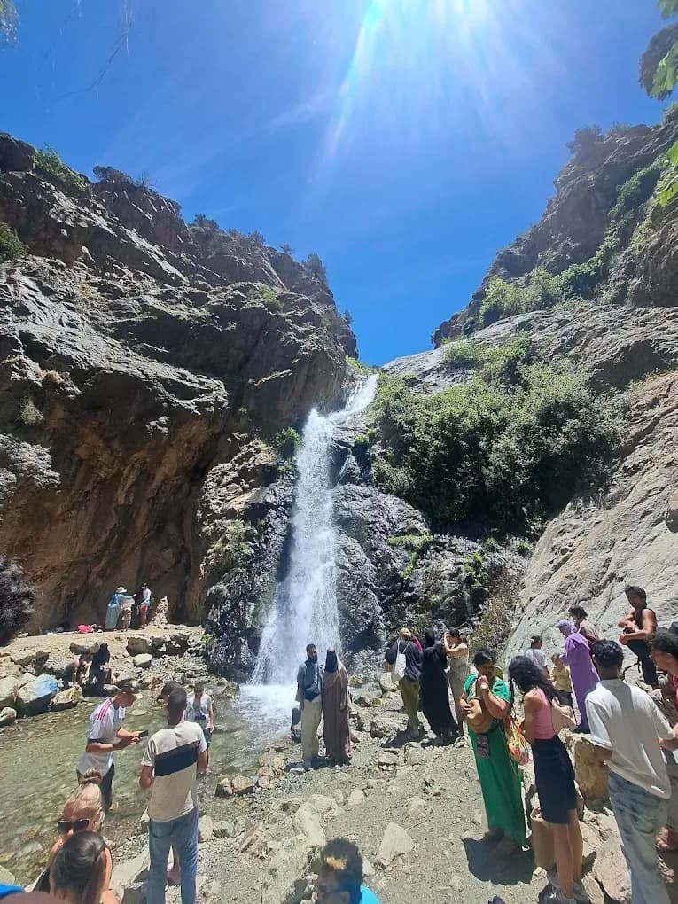 Group of travellers at a waterfall in the Atlas