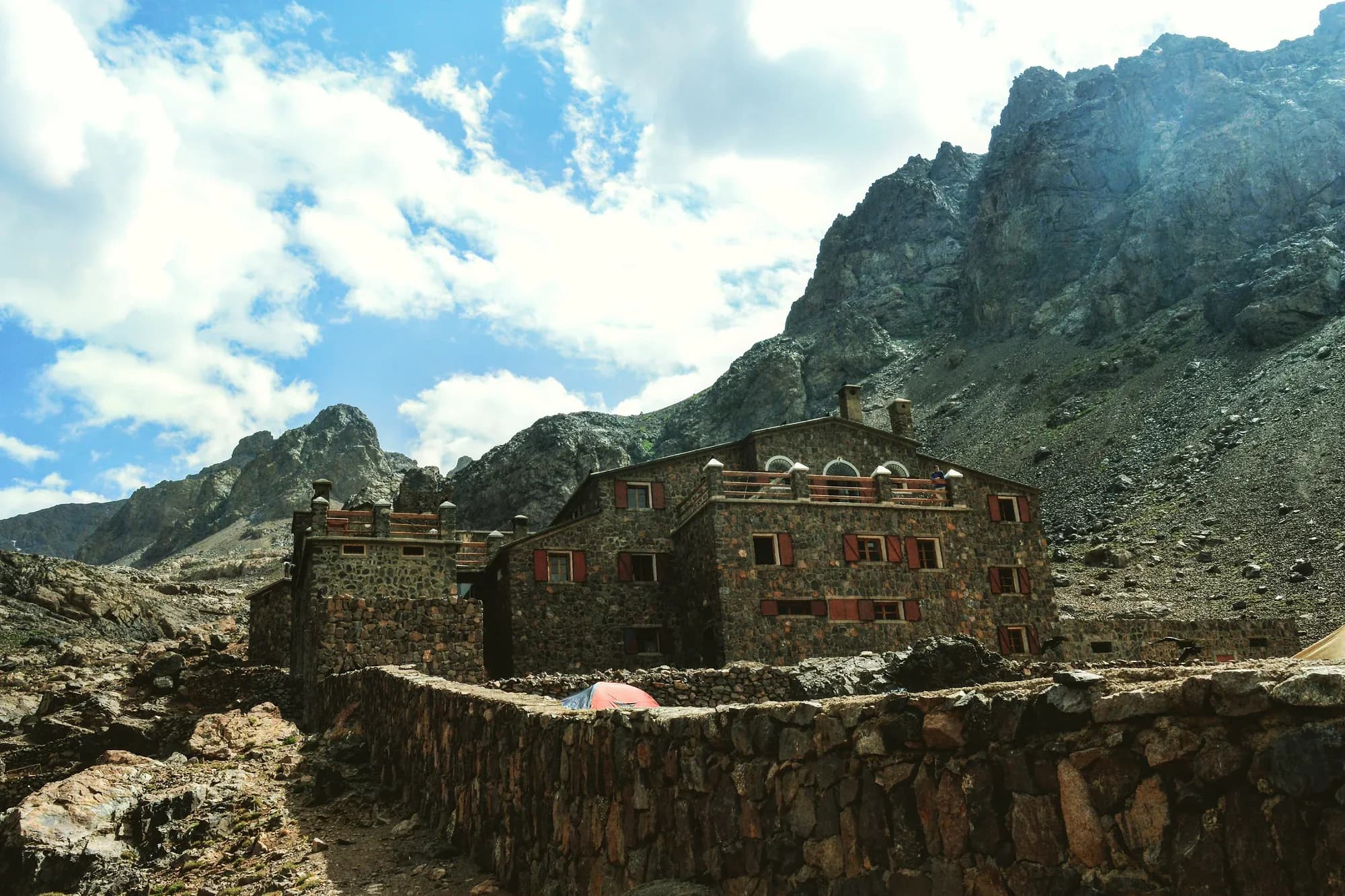 Stone building of the Toubkal refuge among rocky High Atlas peaks