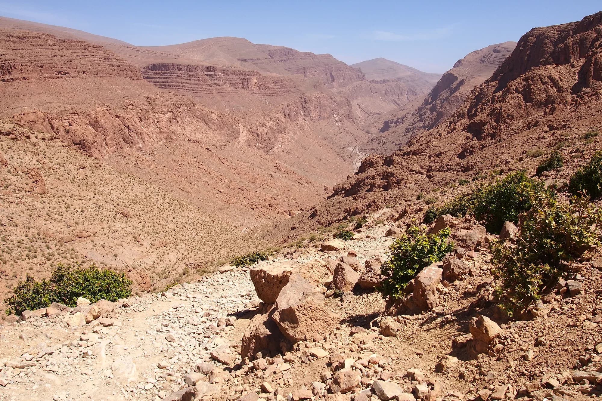 Trail among rocks in the upper Todra Gorge, with mountains in the background