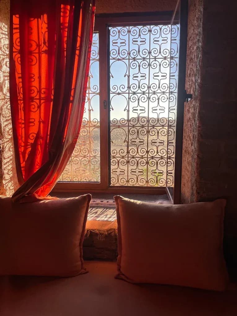 Kasbah window with red curtains